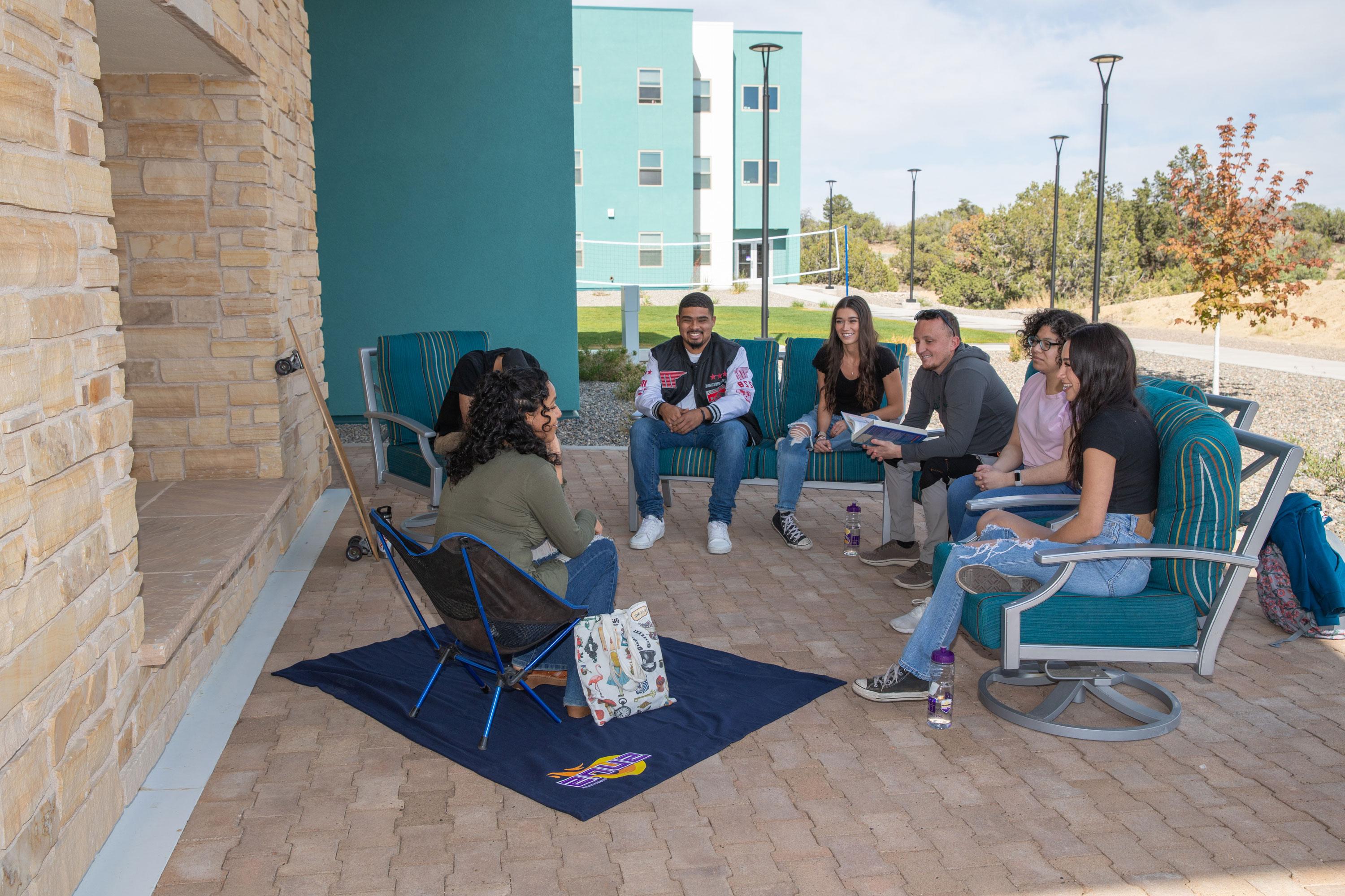 Group of SJC students sitting together and chatting.